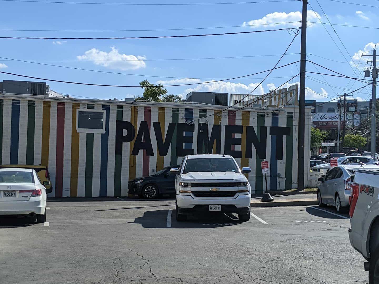 The rainbow striped storefront of Pavement resale shop in Austin
