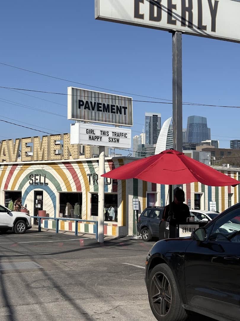 The Pavement store sign with the Austin skyline behind it