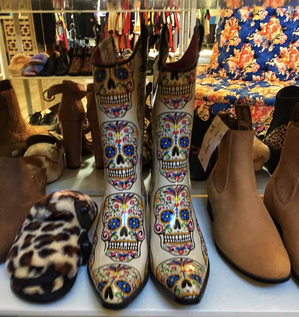 Colorful sugar skull cowboy boots and shoes on display at Pavement in Austin