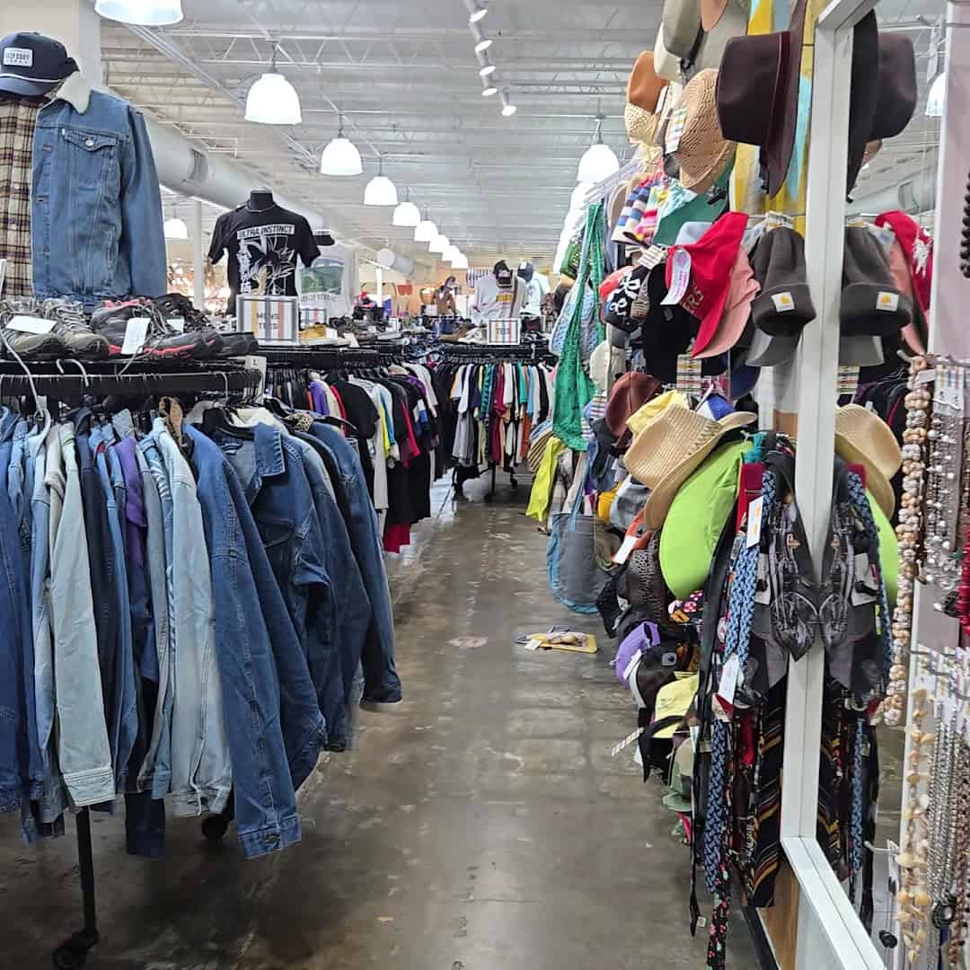 Racks of vintage denim jackets and clothing at Pavement in Austin