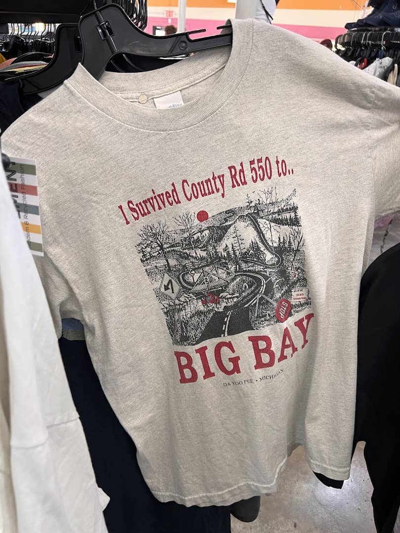 Vintage graphic sweatshirt on a hanger at Pavement resale shop in Austin