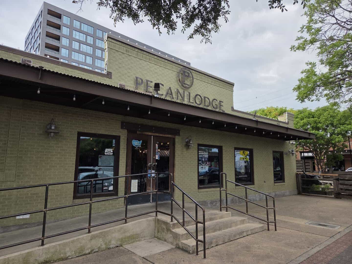 Pecan Lodge sign on the brick exterior in Deep Ellum, Dallas
