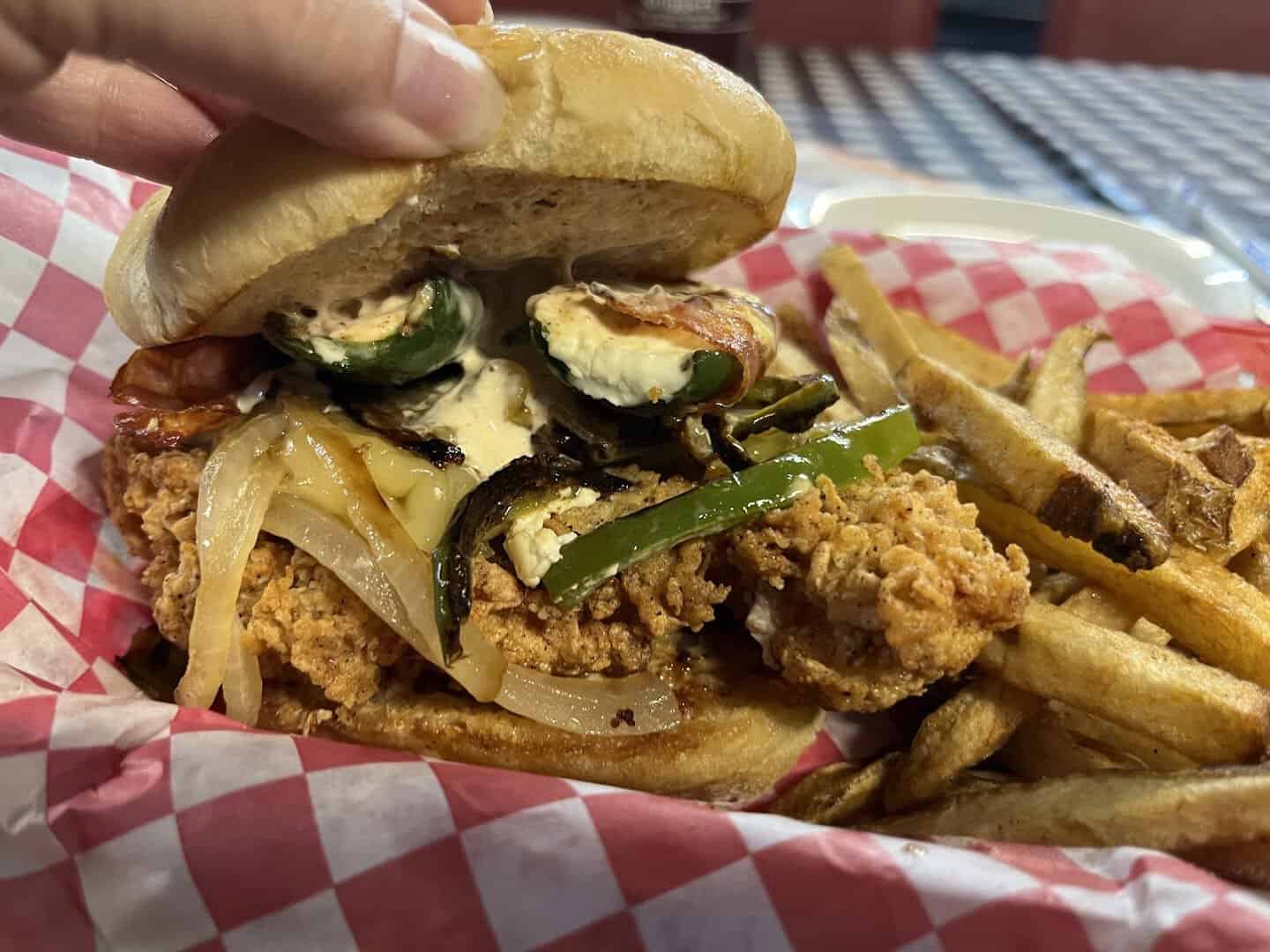Philly cheesesteak sandwich over fries at Mel's Diner in Mingus, Texas