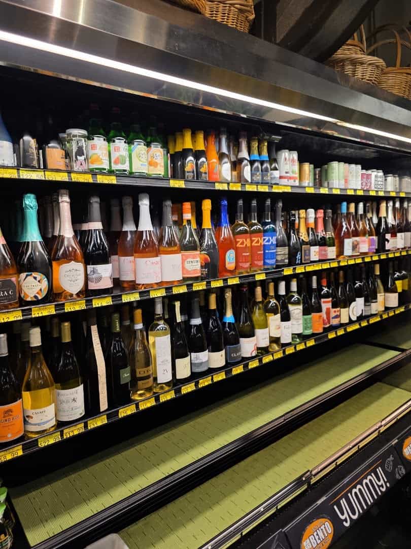 Shelves of imported oils and wine at Phoenicia Specialty Foods in Houston