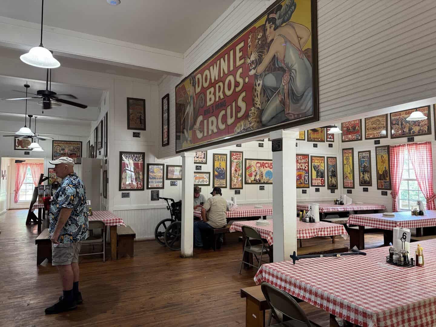Vintage circus posters on the dining room walls at Pickett House Restaurant in Woodville, Texas