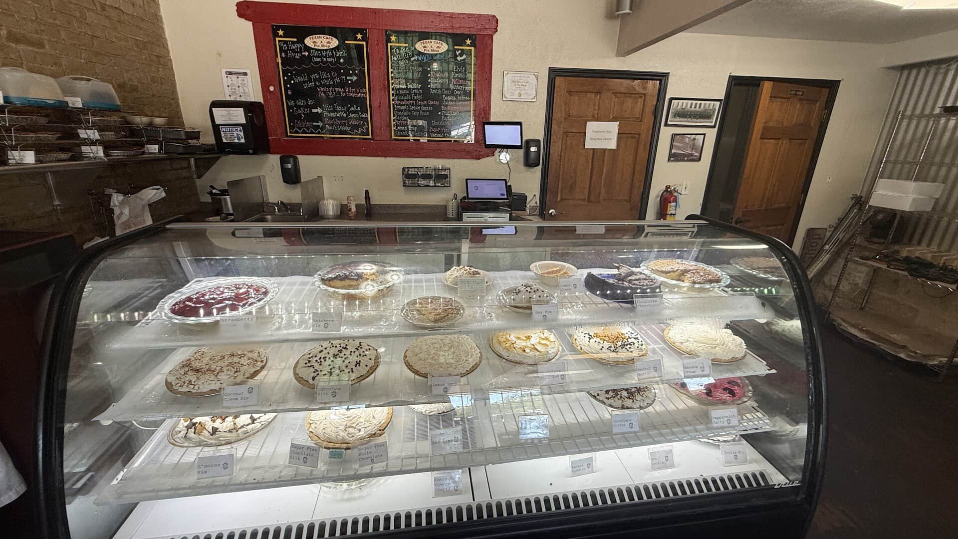 Glass pie display case and chalkboard menu at Texan Cafe and Pie Shop in Hutto, Texas