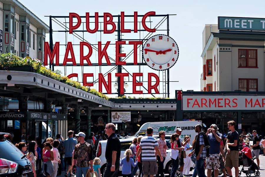 Iconic Public Market Center neon sign and clock at Pike Place Market in Seattle