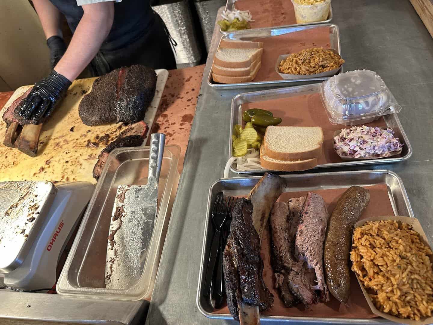 Staff slicing brisket at the counter of Pinkerton's Barbecue in Houston