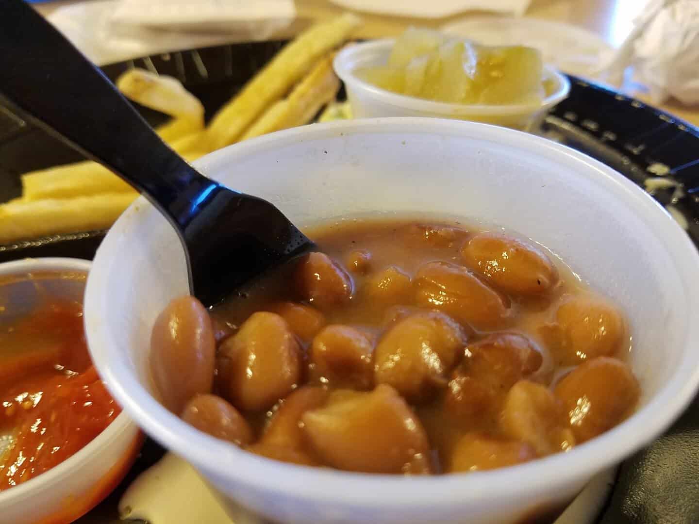 Cup of seasoned pinto beans with fries at Catfish King in Waco, Texas