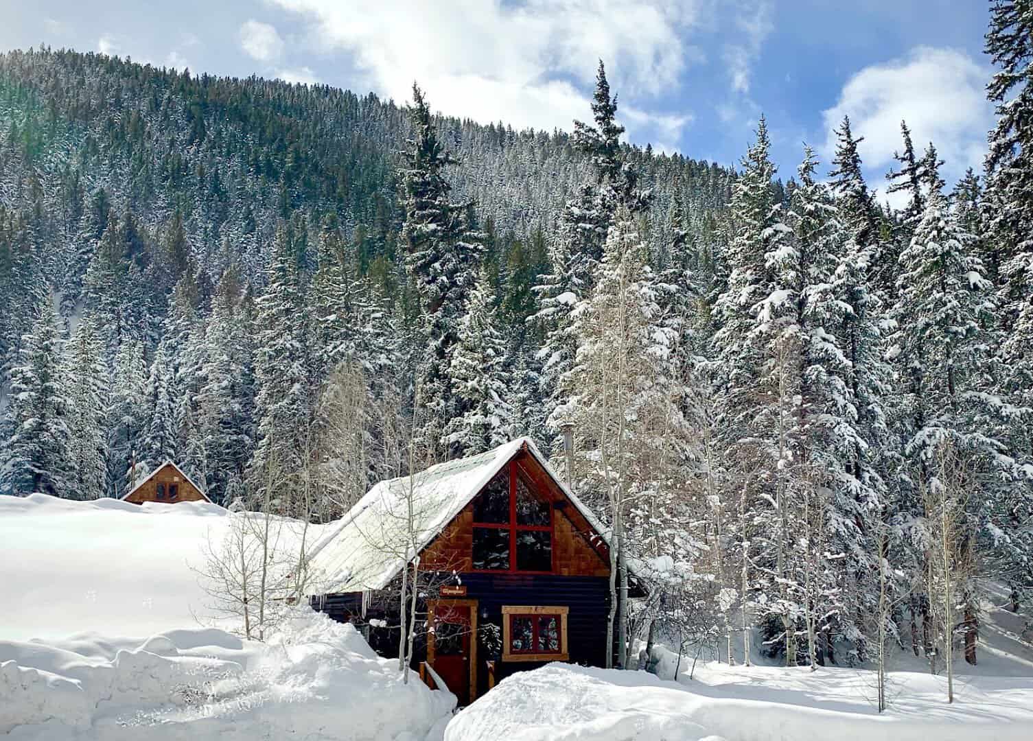 Log cabin in fresh snow at Pioneer Guest Cabins near Crested Butte, Colorado