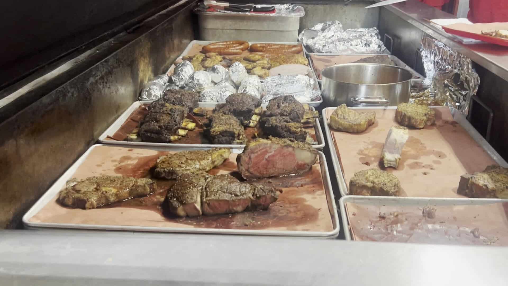 Steaks, prime rib and pork chops resting in the pit at Cooper's in Fort Worth