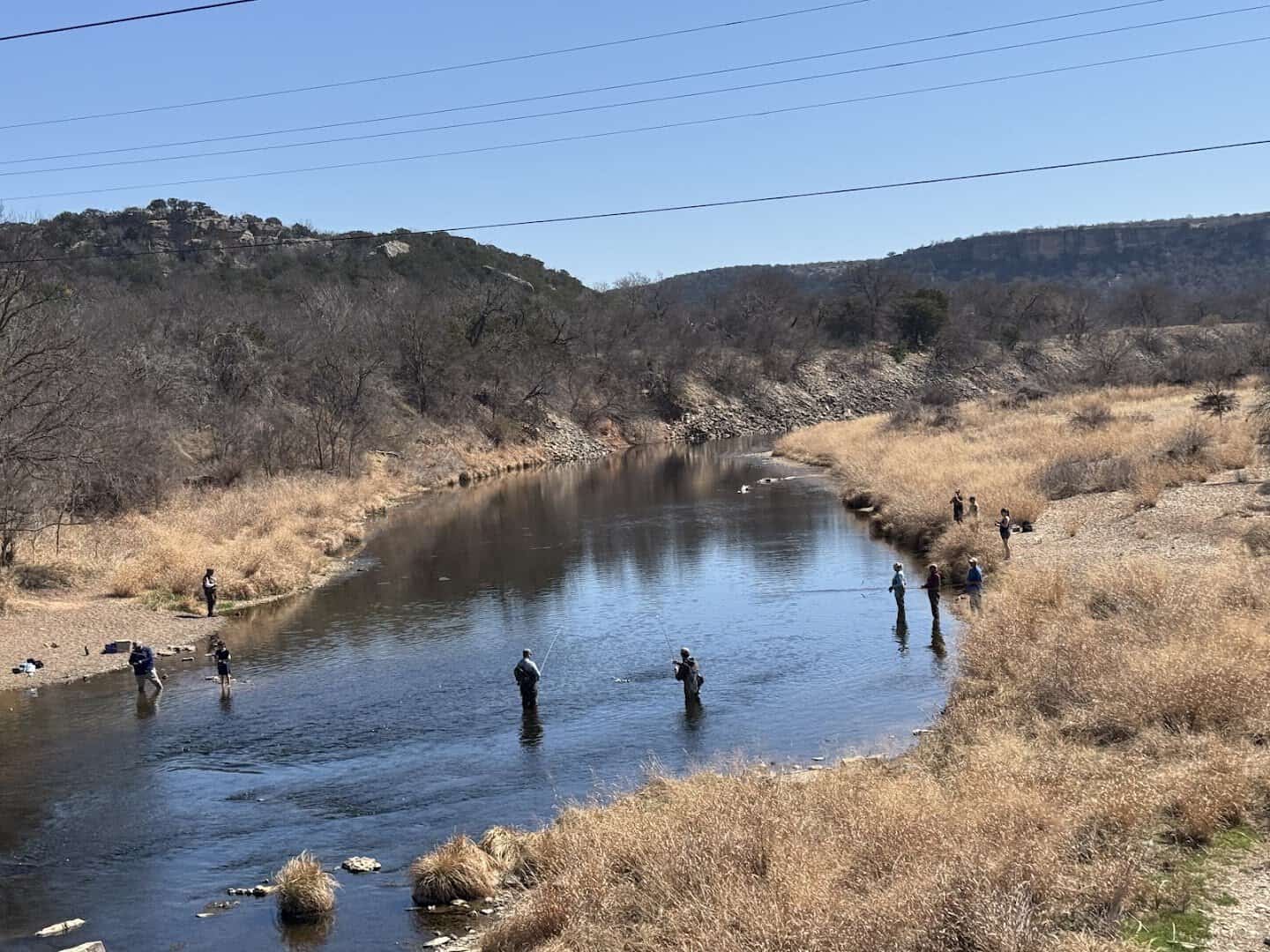People fishing the clear Brazos River in the canyon country below Possum Kingdom Lake