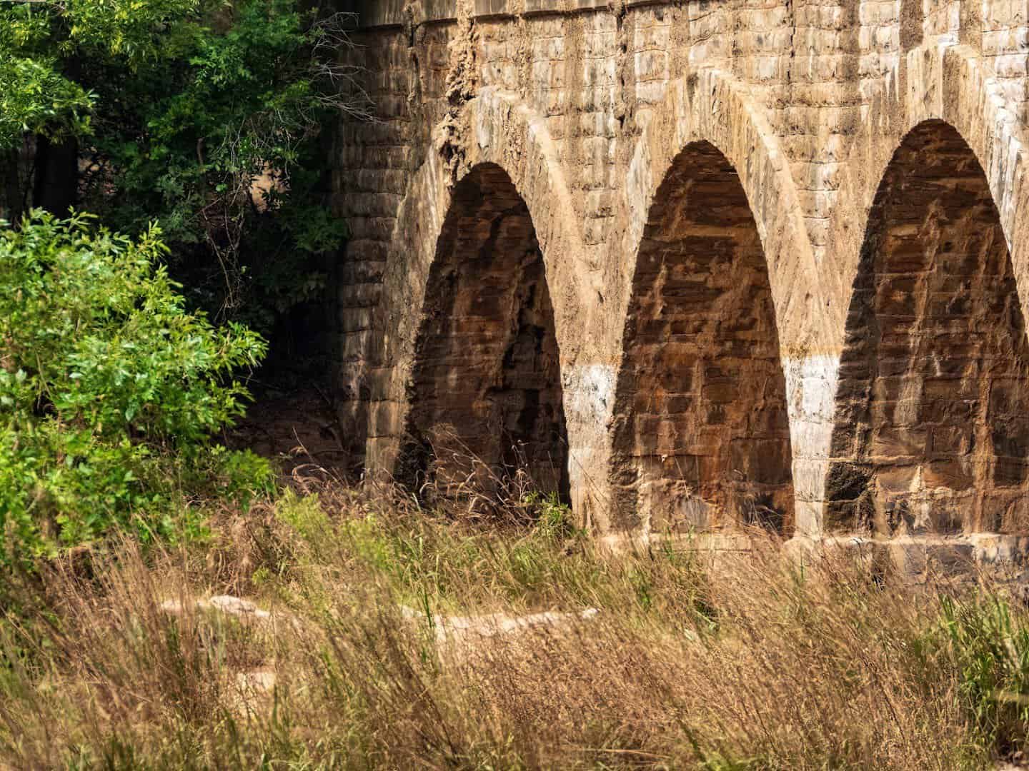 Row of limestone arches along the side of the Possum Kingdom Stone Arch Bridge over the Brazos River