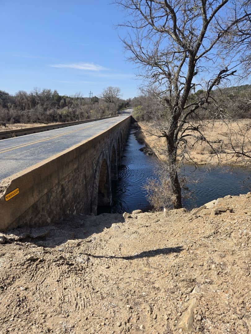 The narrow two-lane roadway on top of the historic Possum Kingdom Stone Arch Bridge