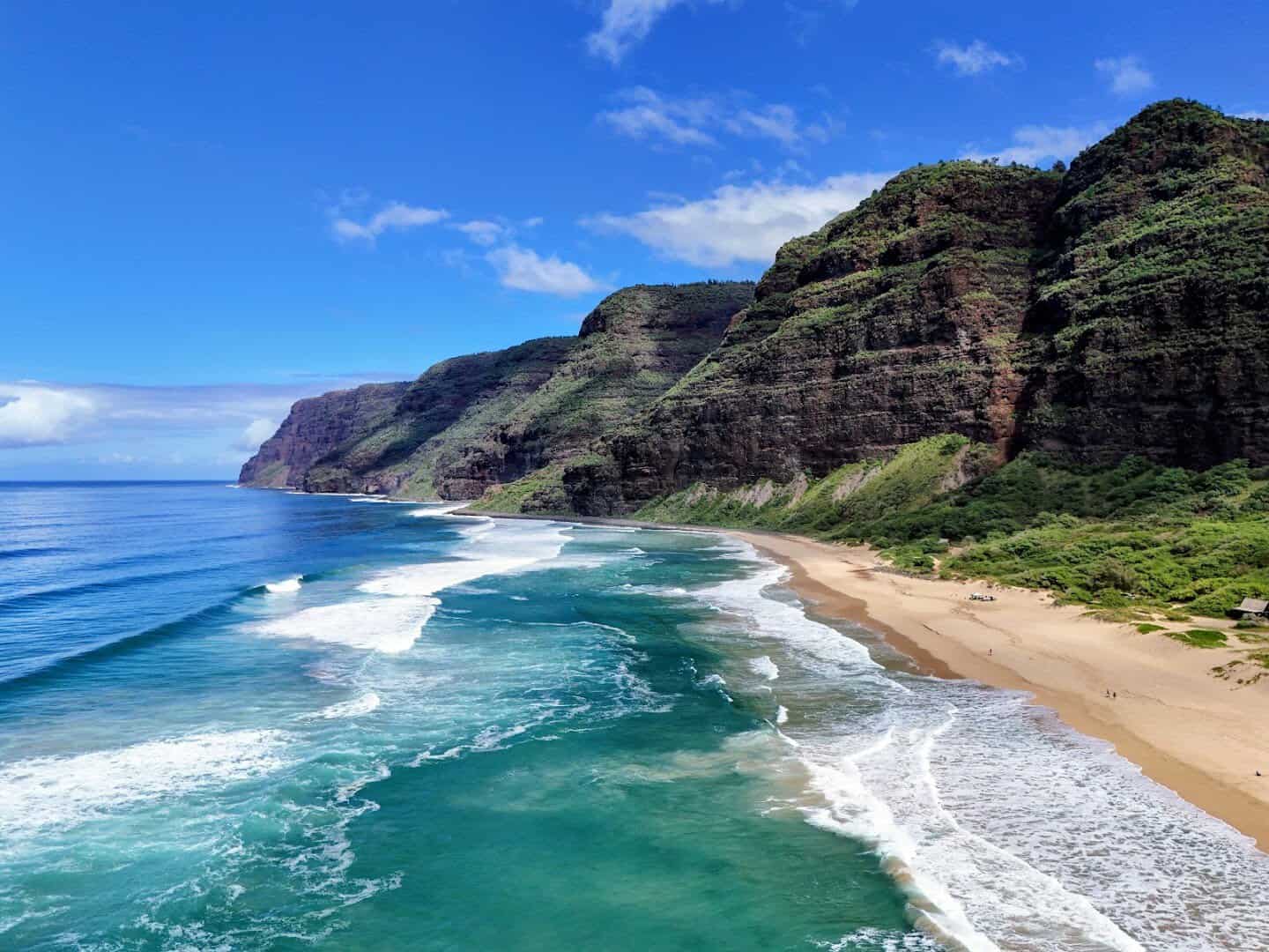 Na Pali cliffs meeting the wild shoreline at Polihale State Park, Kauai, Hawaii