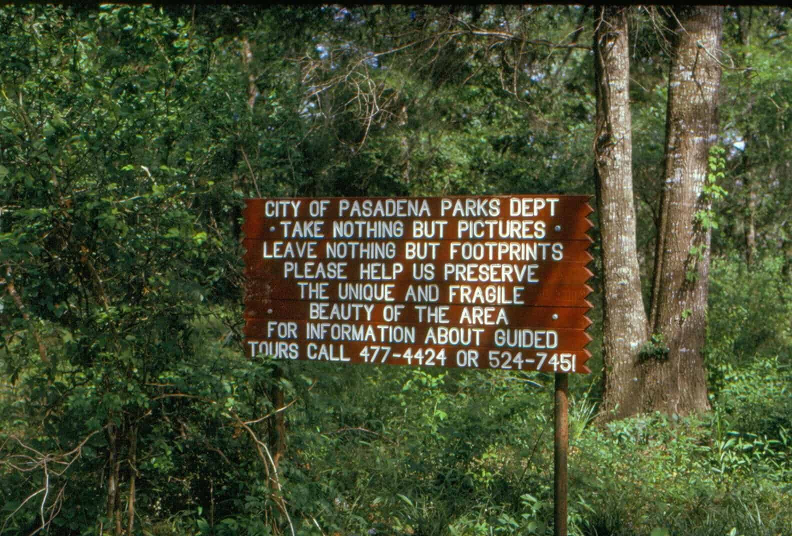 Wooden park sign at the entrance to the Armand Bayou preserve in Pasadena, Texas