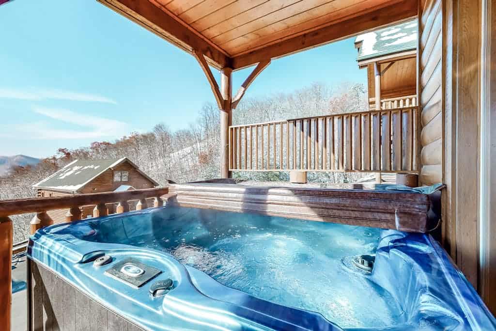 Cabin deck hot tub with a Smoky Mountain view at The Preserve Resort in Wears Valley, Tennessee