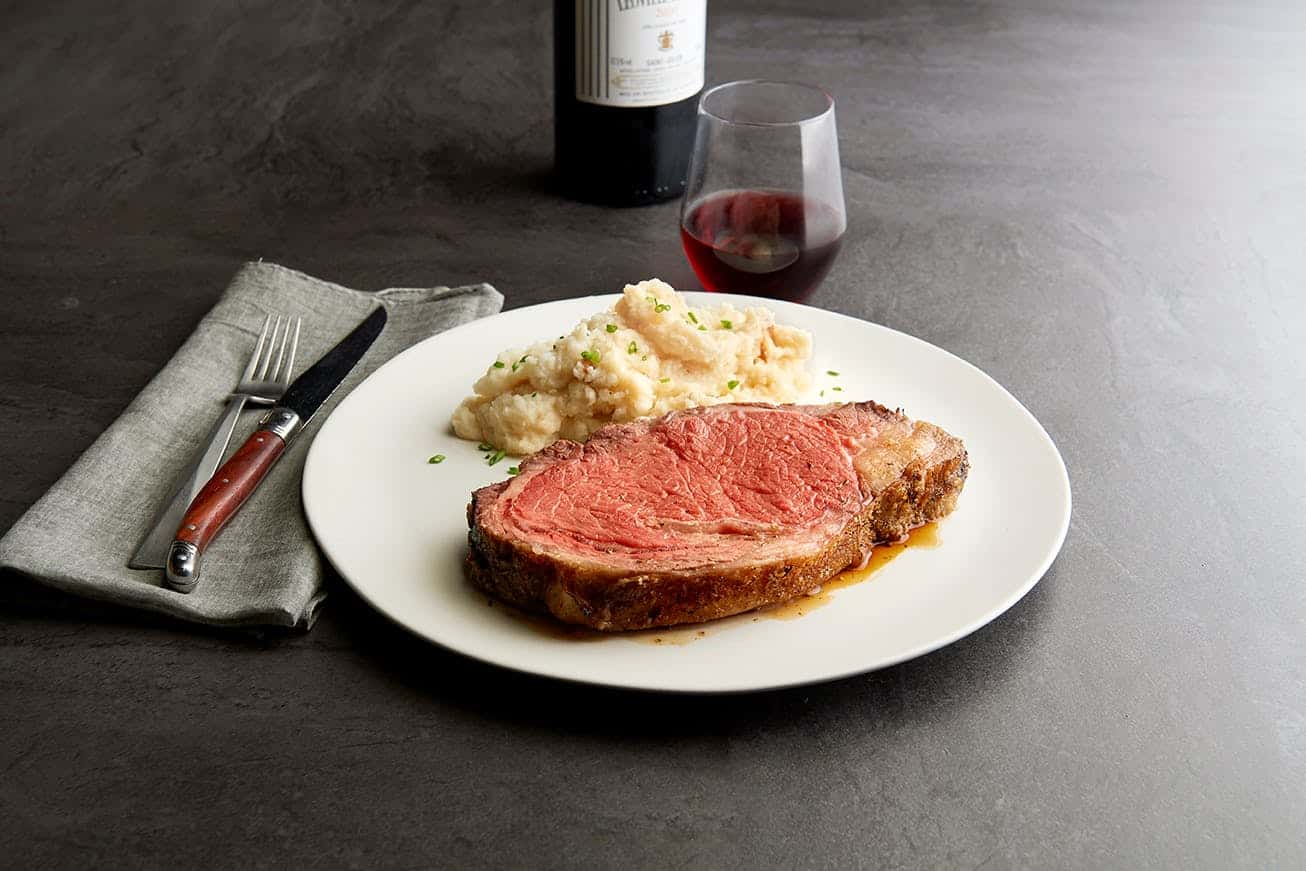 Slow roasted prime rib plated with red wine at Chart House in San Antonio