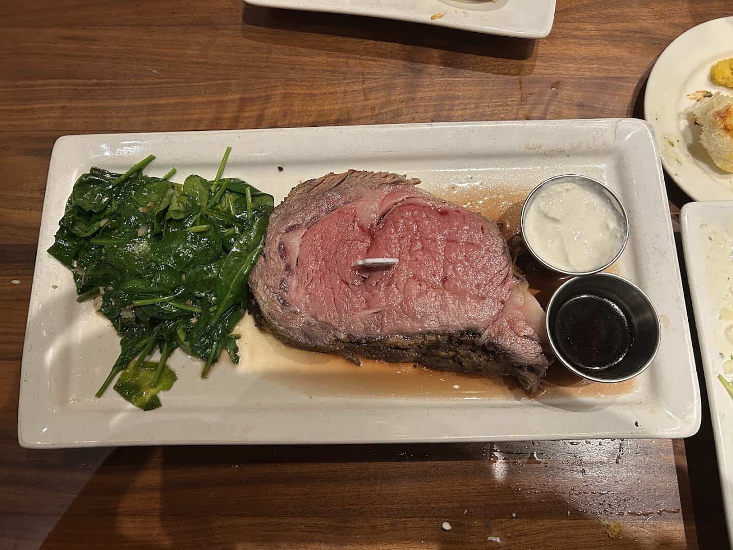 Slice of prime rib with spinach at Taste of Texas in Houston