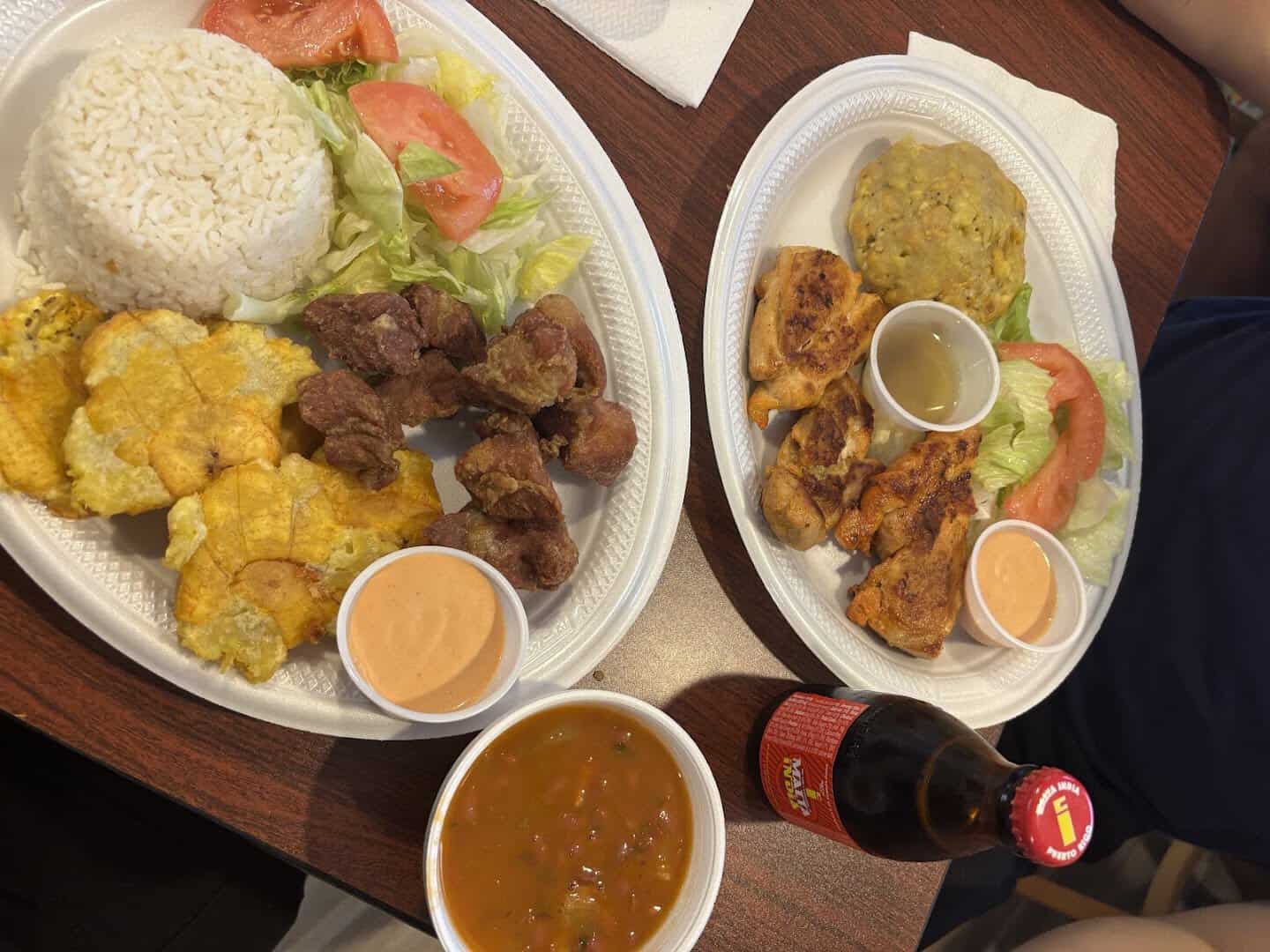 Two heaping plates of Puerto Rican food at Tex-Chick in Houston
