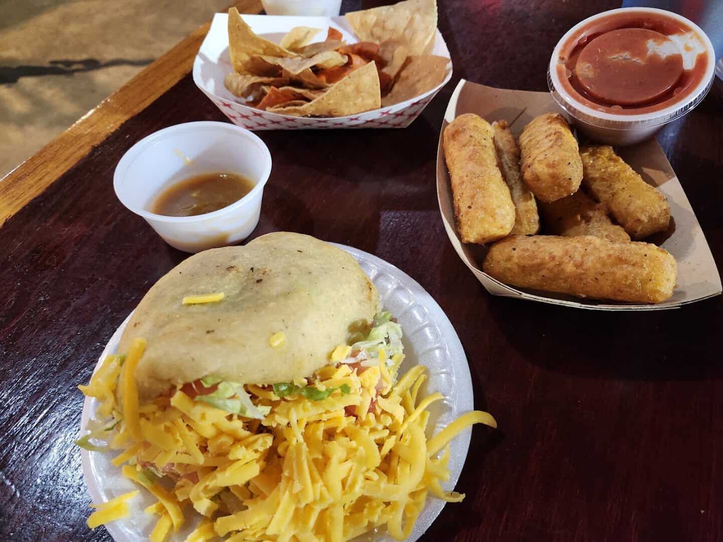 Puffy taco with cheese and fried sides at Ray's Drive Inn in San Antonio