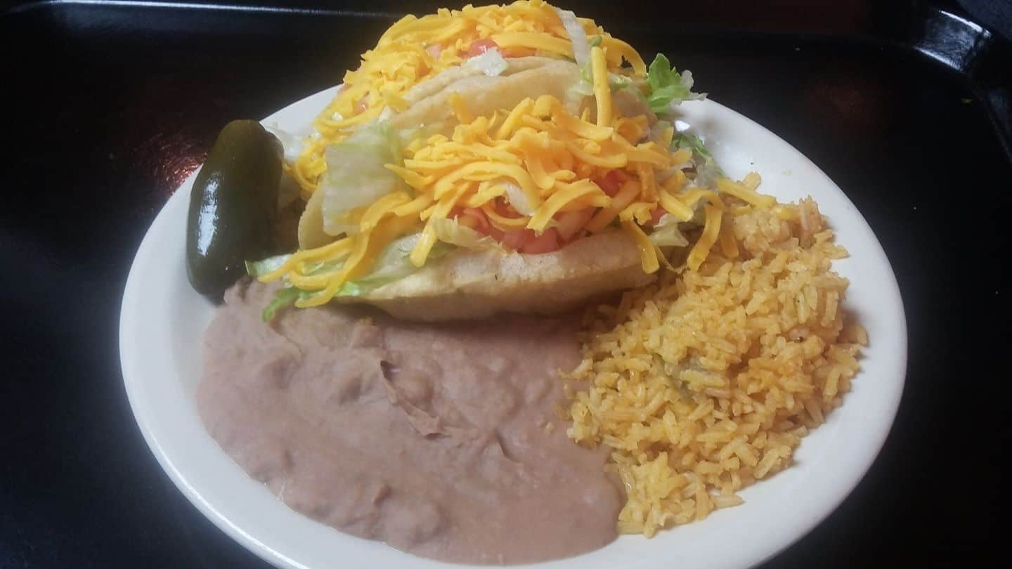 Single puffy taco plate with rice and refried beans at Ray's Drive Inn in San Antonio