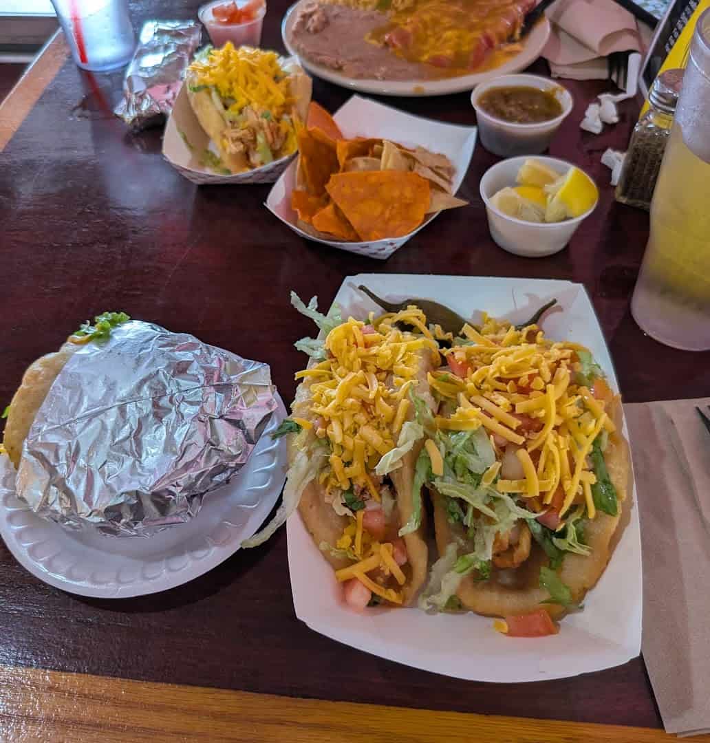 Puffy tacos topped with cheese and pico at Ray's Drive Inn in San Antonio