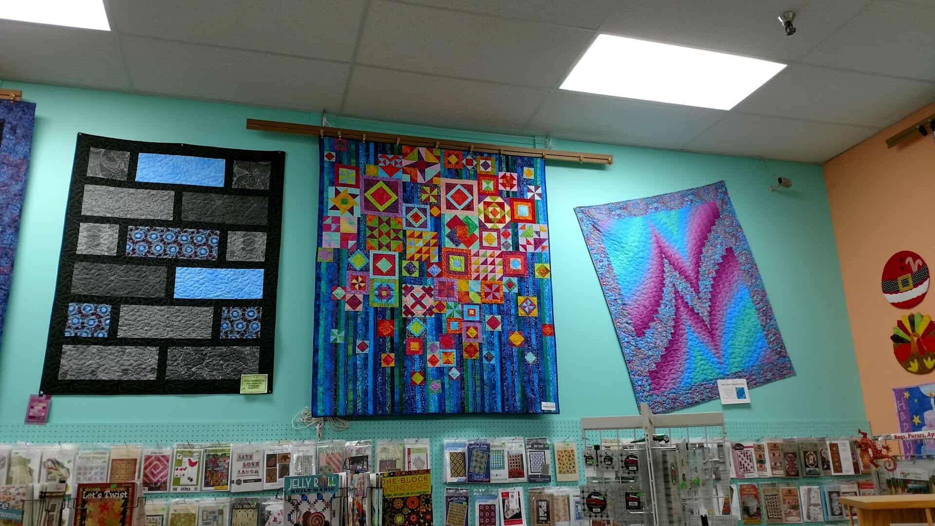 A wall of quilt block and pattern samples inside Quilt Country in Lewisville, Texas