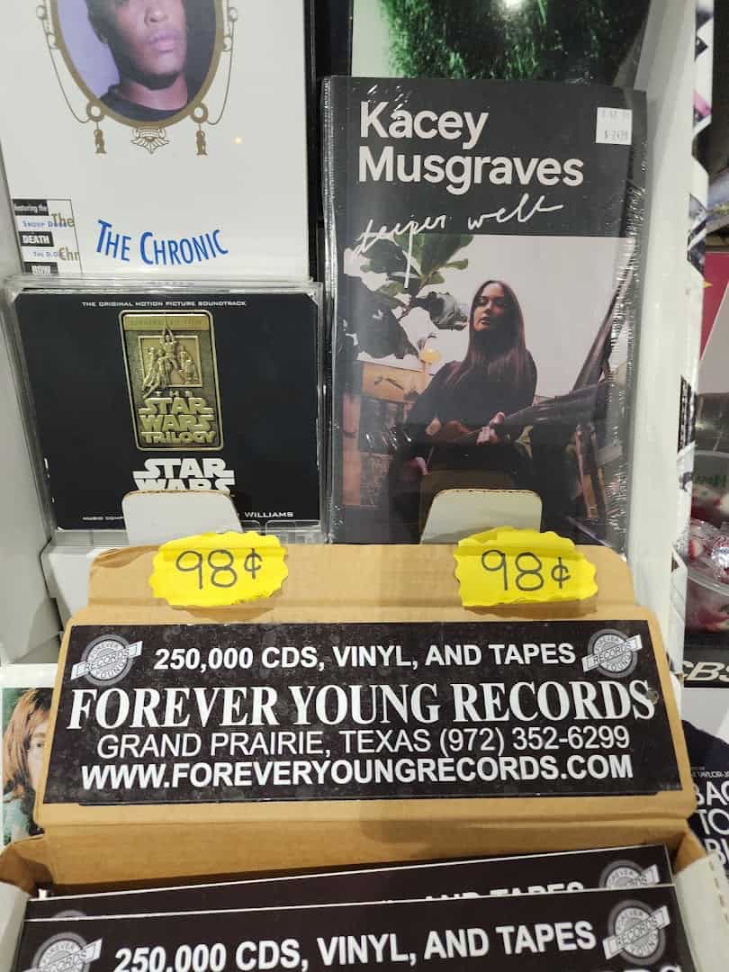 Rare and collectible records beneath the store sign at Forever Young Records in Grand Prairie, Texas