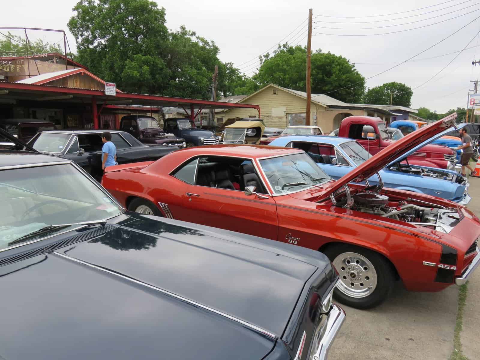 Exterior of Ray's Drive Inn with classic cars in the lot in San Antonio