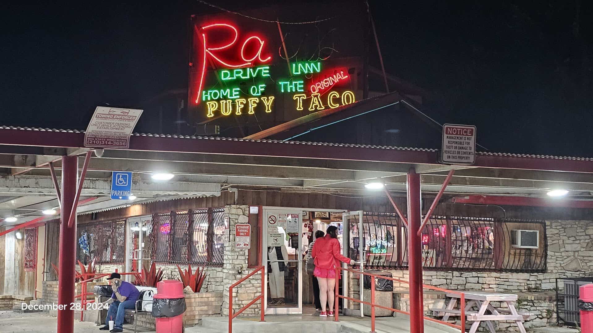 Neon sign reading Home of the Original Puffy Taco at Ray's Drive Inn in San Antonio