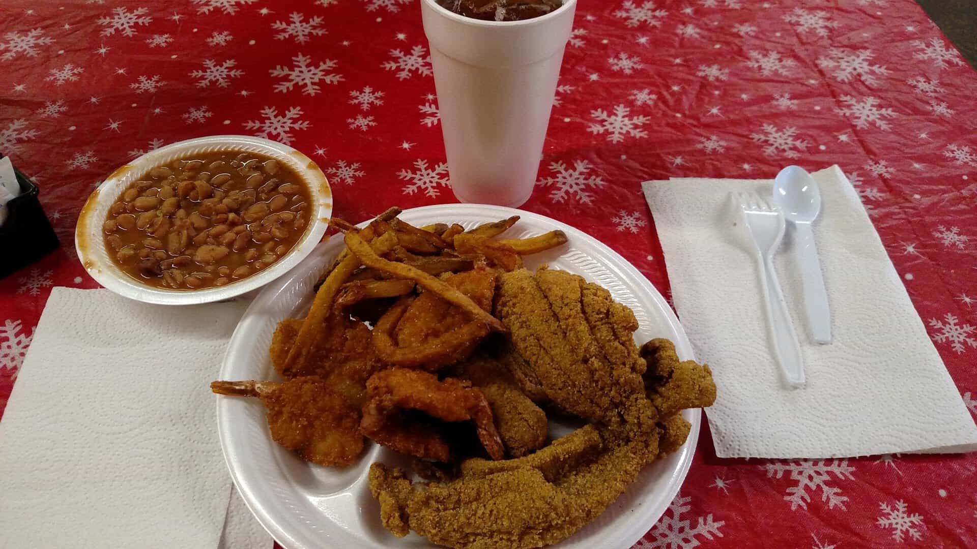 Plate of fried catfish with fries and beans at The Red Barn in Wills Point, Texas