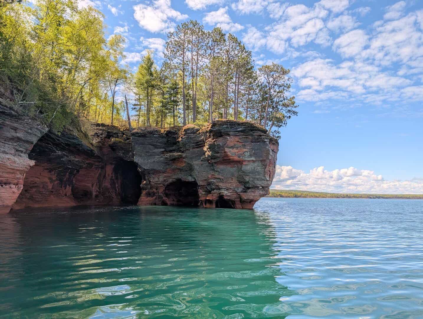 Red sandstone sea caves rising from the clear water at Apostle Islands National Lakeshore, Wisconsin