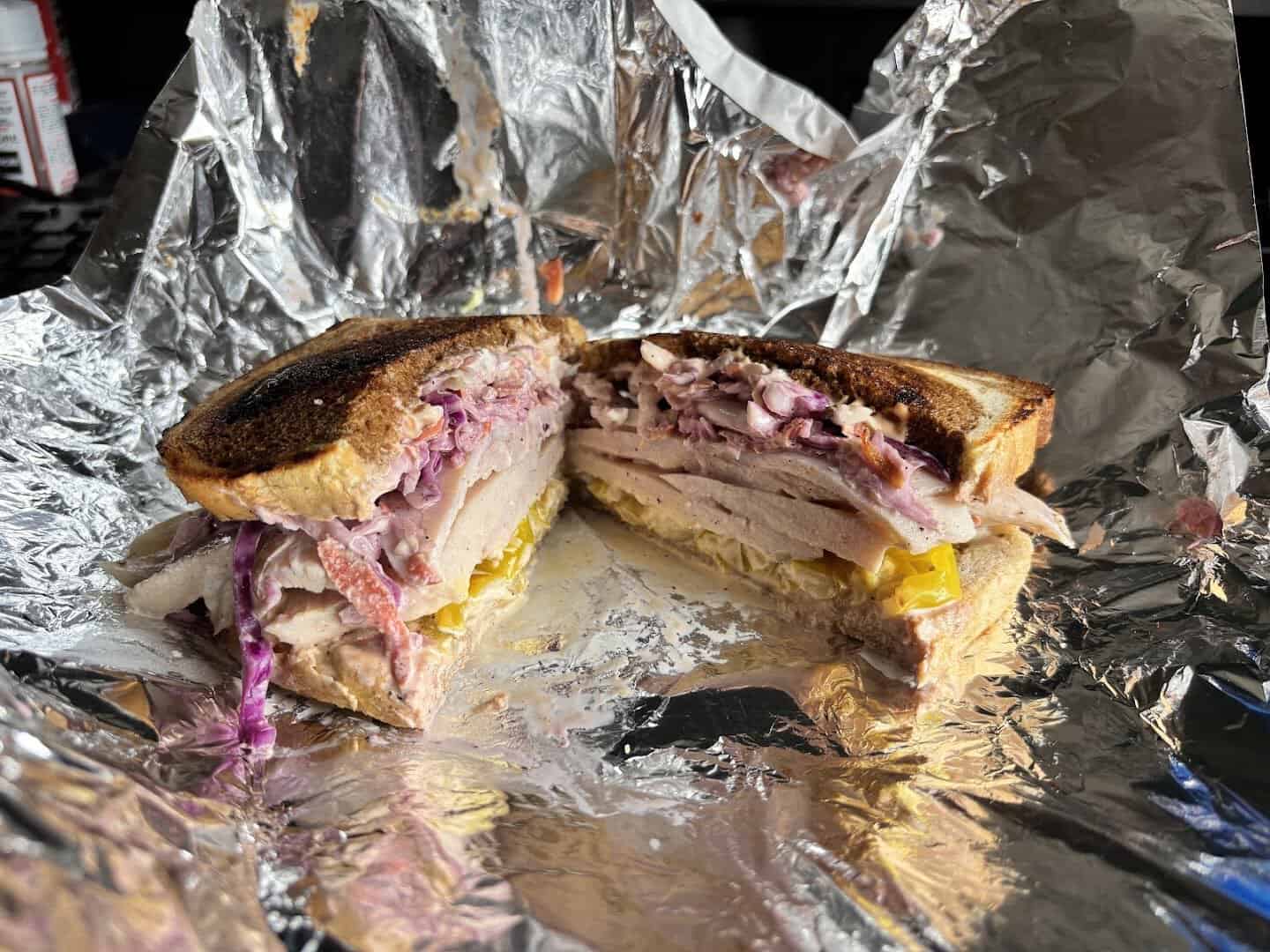 Reuben sandwich unwrapped from foil at Otherside Deli in Austin