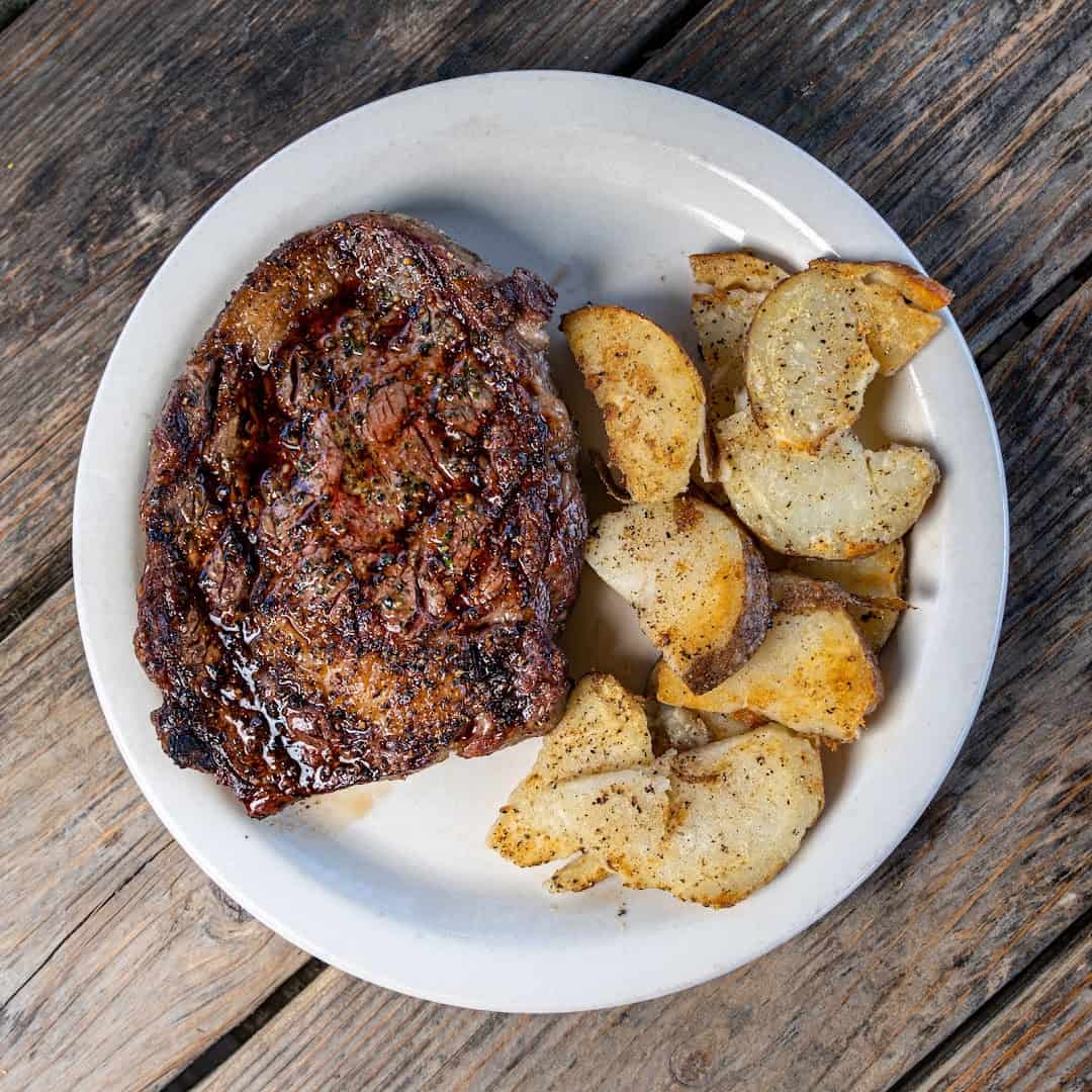 Ribeye steak dinner with potato wedges at Roadhouse in Bastrop, Texas