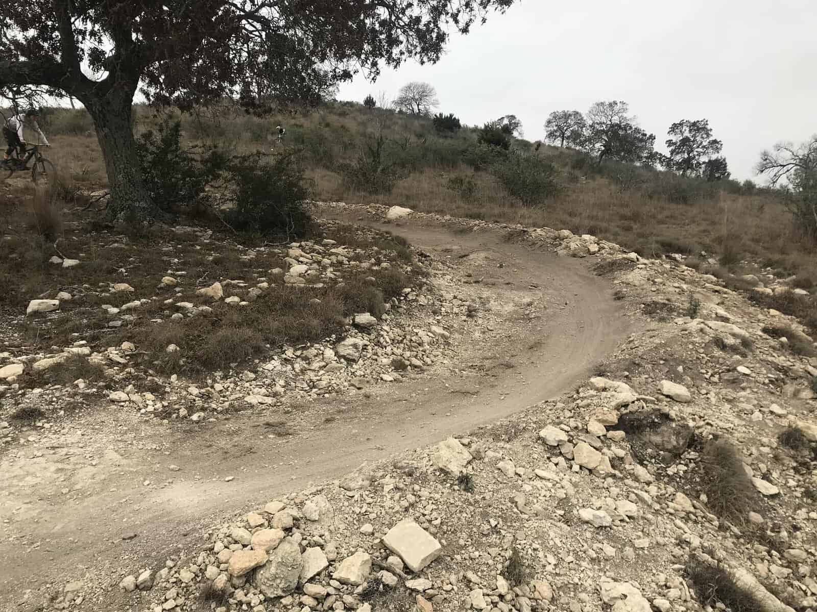 Rocky singletrack trail twisting through the Hill Country at Flat Rock Ranch