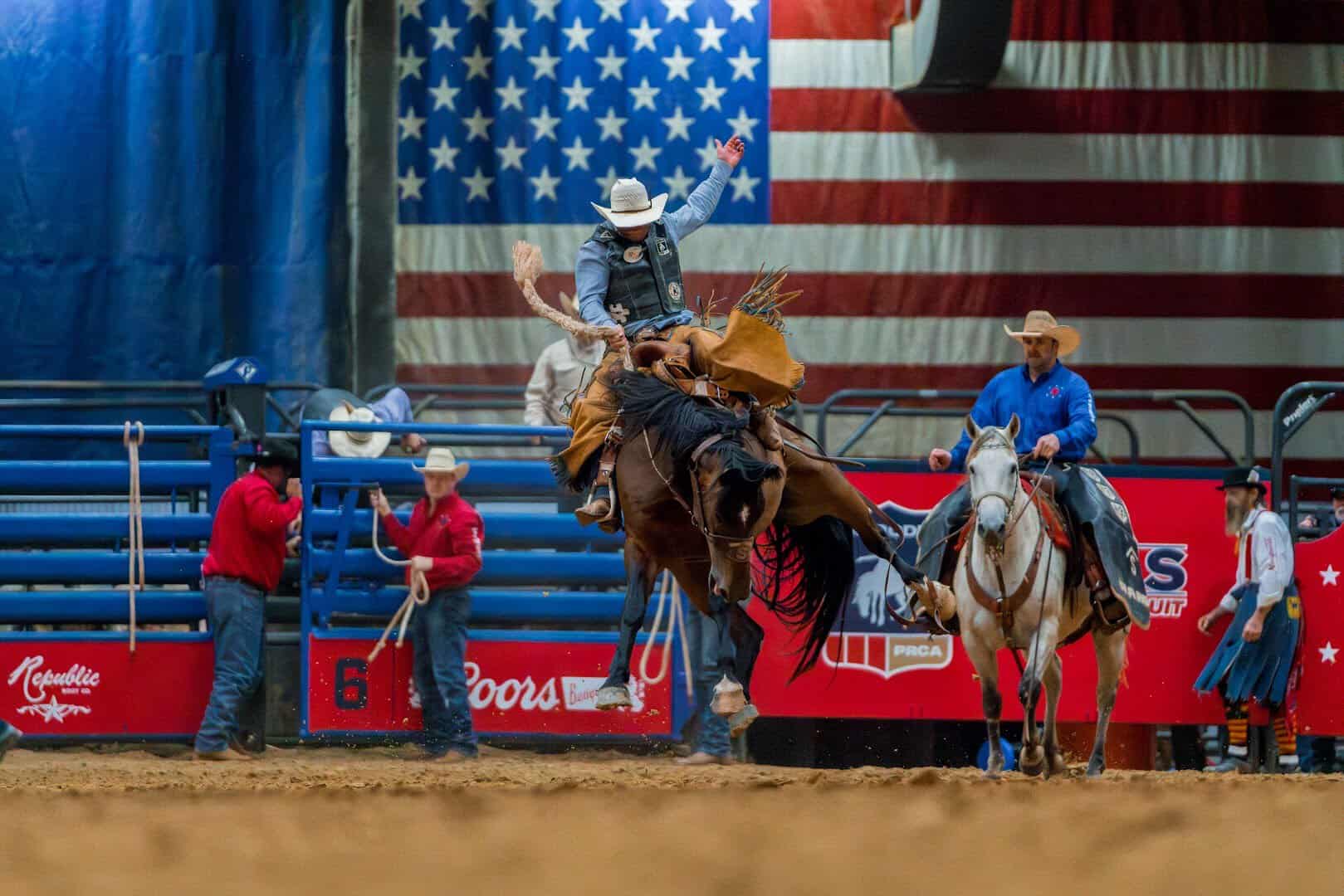 Cowboys and the American flag during the grand entry at the Mesquite Championship Rodeo