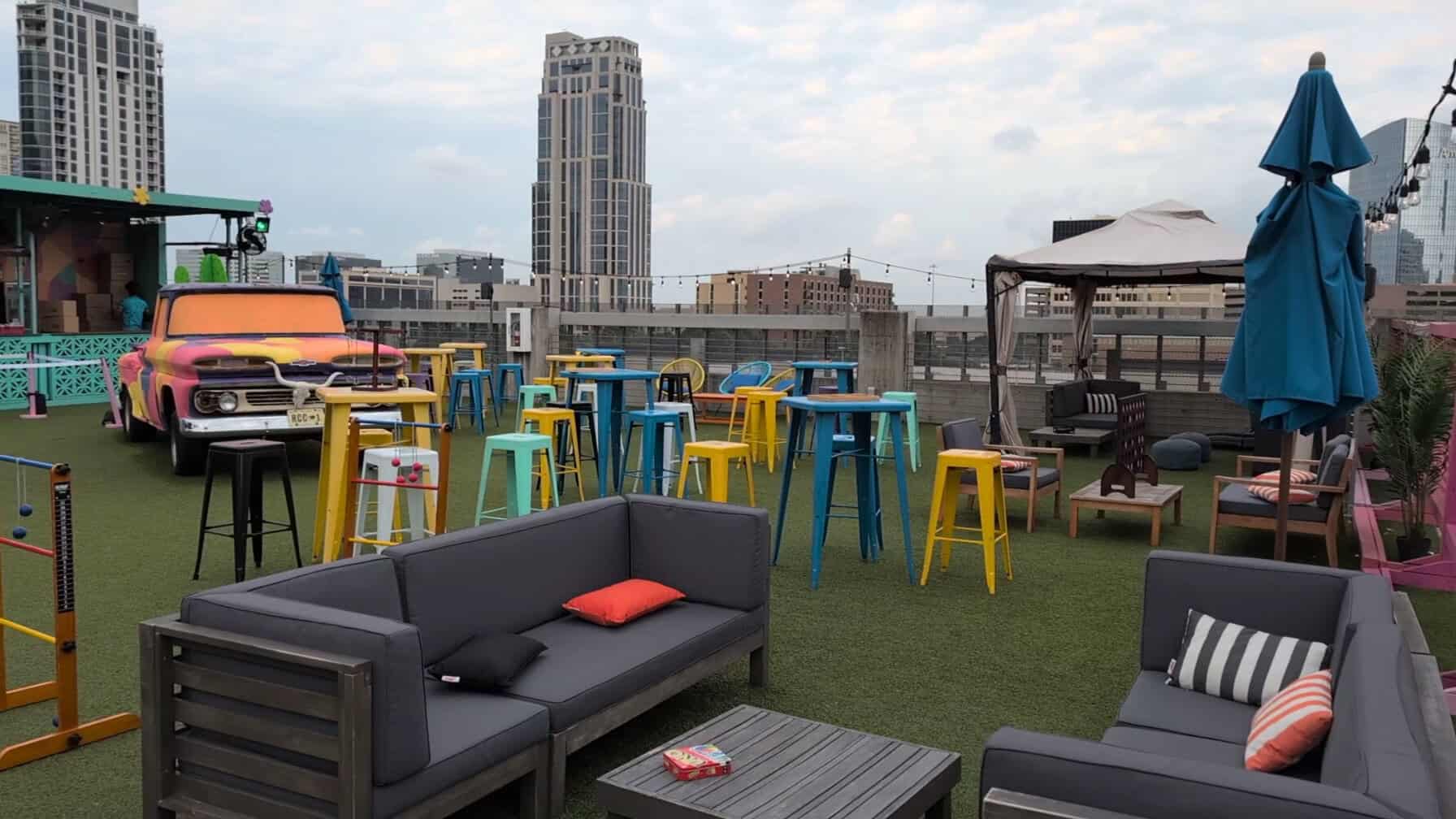 Rooftop lounge with umbrellas and the Houston skyline at Rooftop Cinema Club Uptown