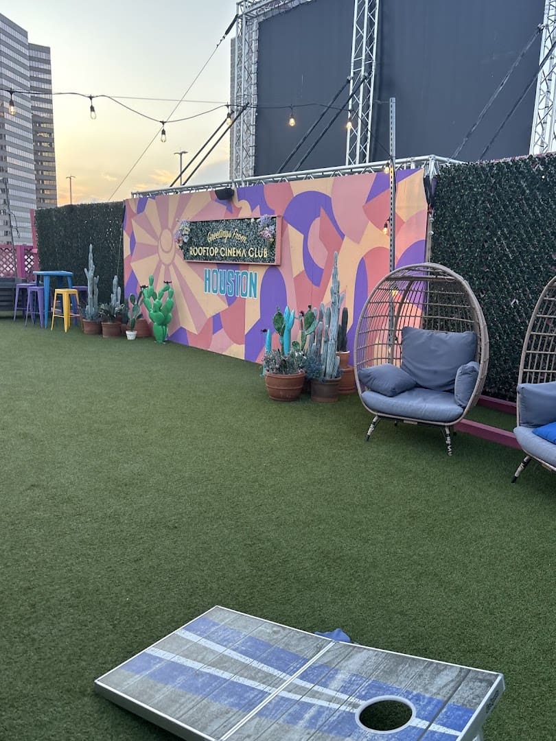 Colorful mural wall and hanging egg chair on the rooftop at Rooftop Cinema Club Uptown in Houston