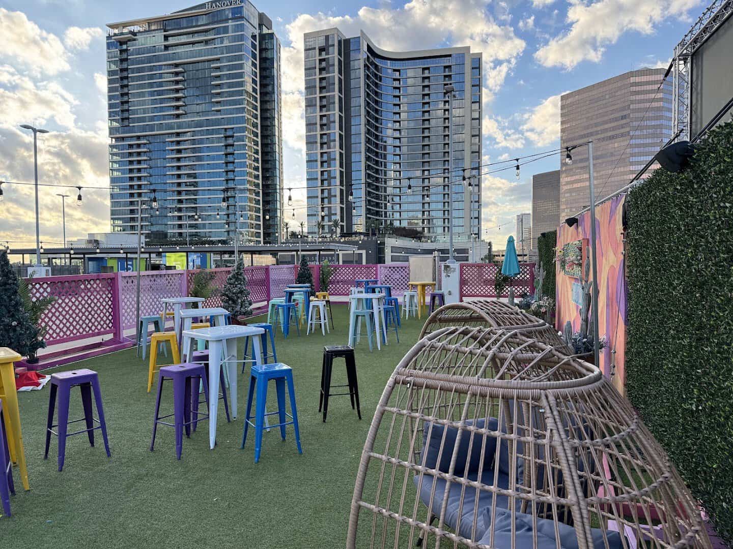 Rooftop terrace with high tables and Houston high-rises at Rooftop Cinema Club Uptown