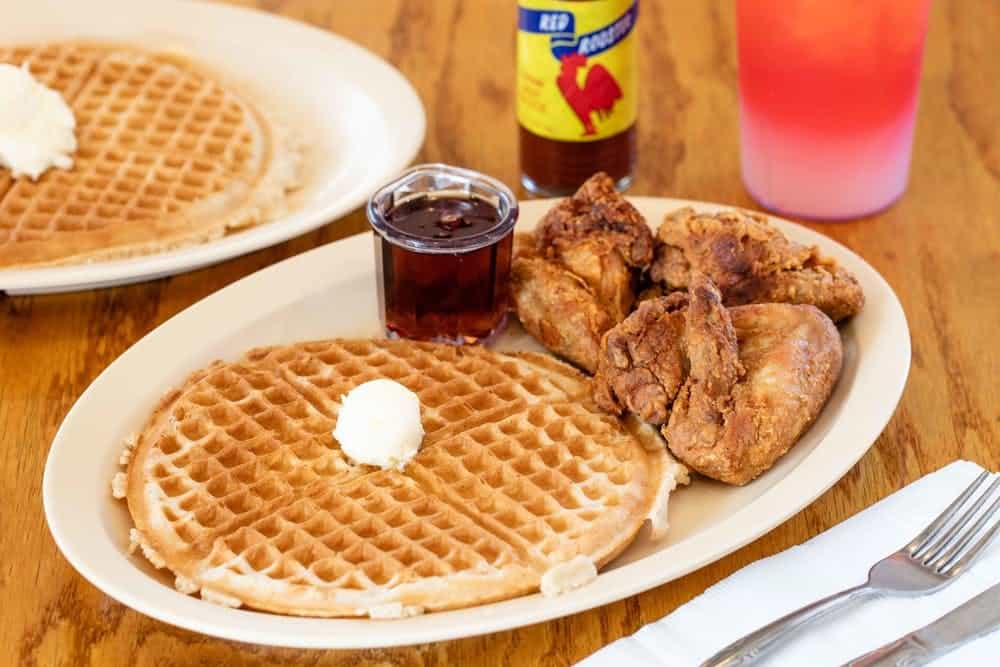 Fried chicken and a waffle on a plate at Roscoe's House of Chicken and Waffles in Los Angeles, California
