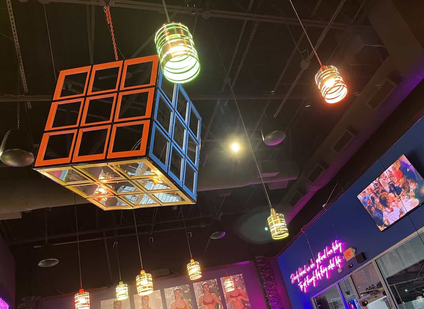 Hanging Rubiks Cube and neon pendant lights at Hungry Like The Wolf in Houston