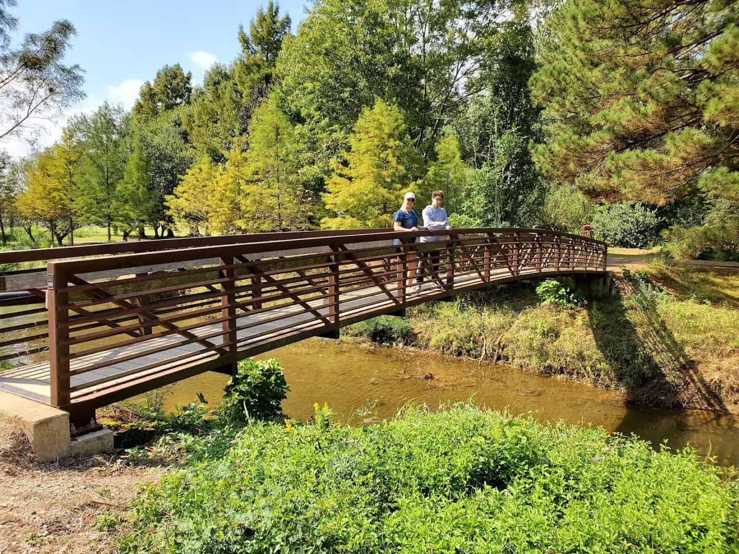 Wooden footbridge over the creek at the Ruby M. Mize Azalea Garden in Nacogdoches, Texas