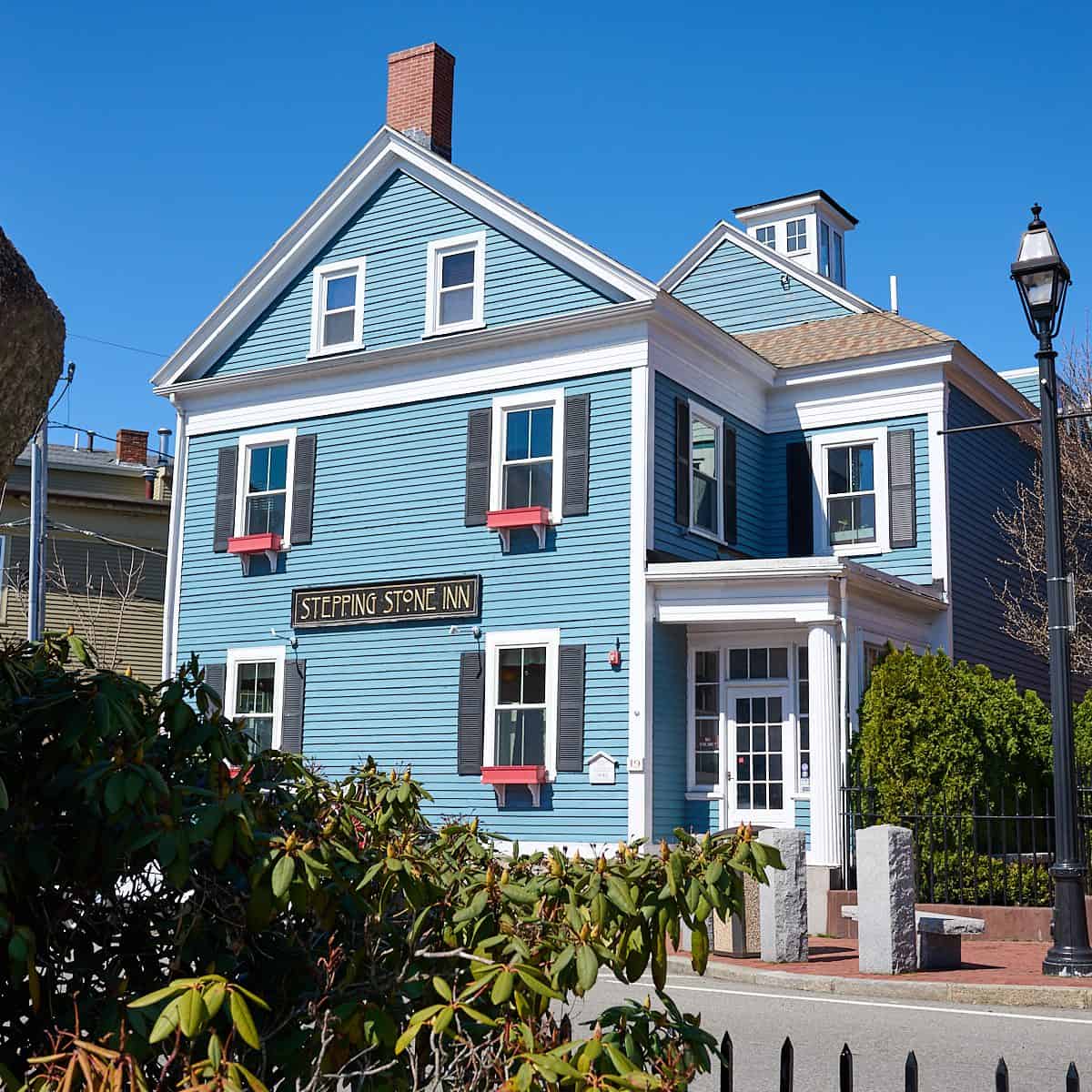 Historic blue Victorian inn on a tree-lined street in Salem, Massachusetts