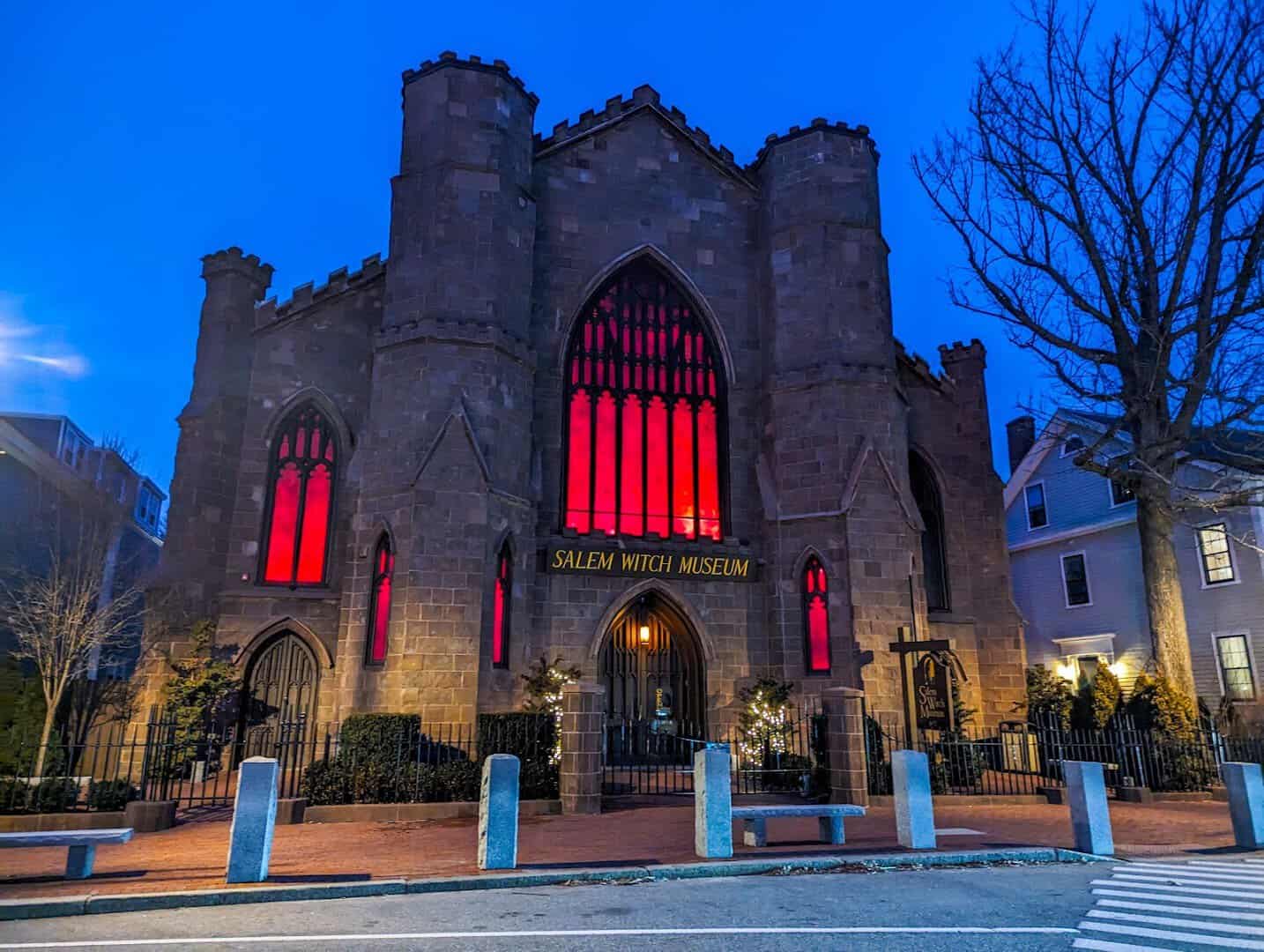 Salem Witch Museum lit red at dusk during Halloween in Salem, Massachusetts
