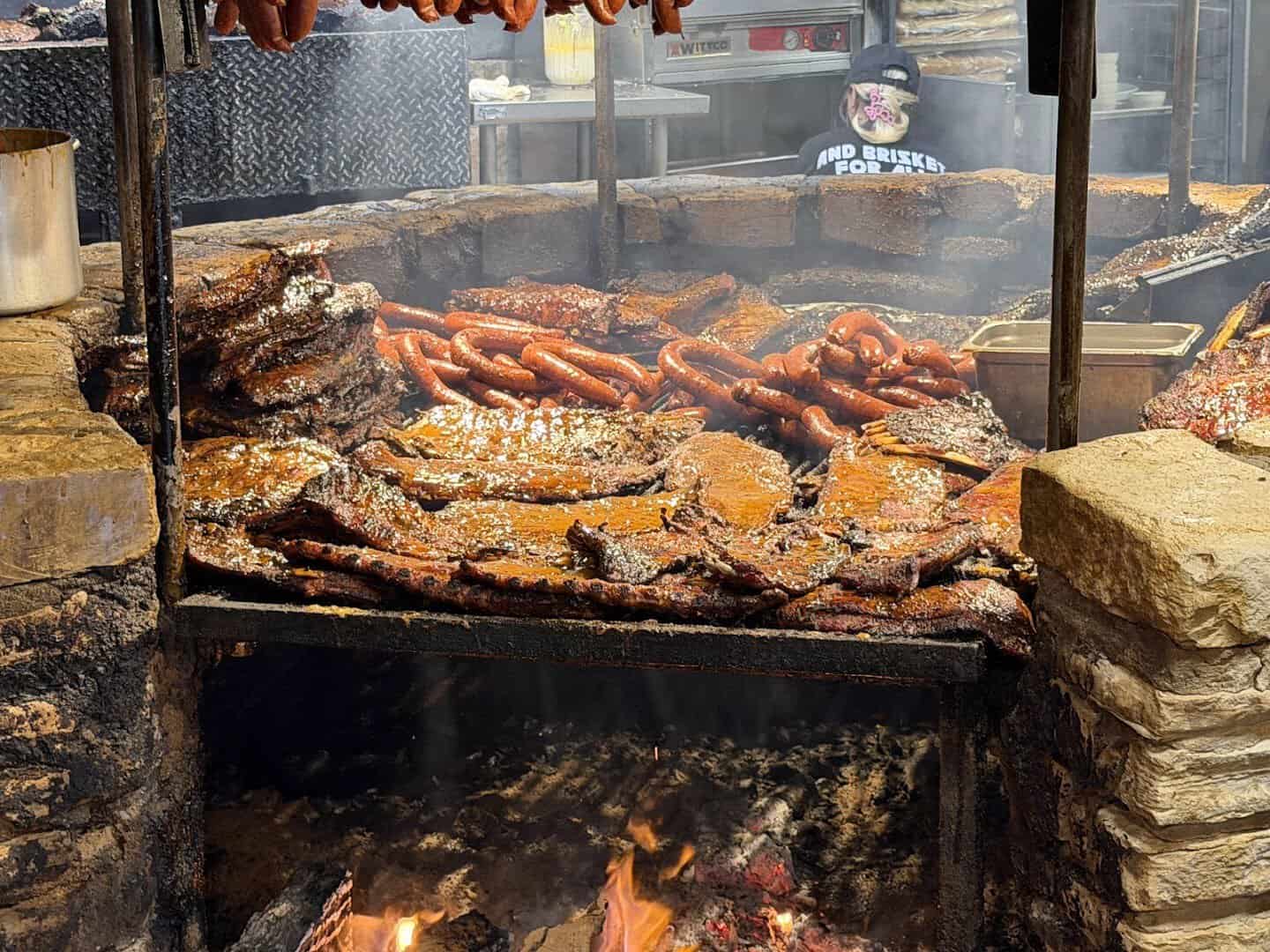 Brisket, ribs and sausage on the open pit at The Salt Lick BBQ in Driftwood, Texas