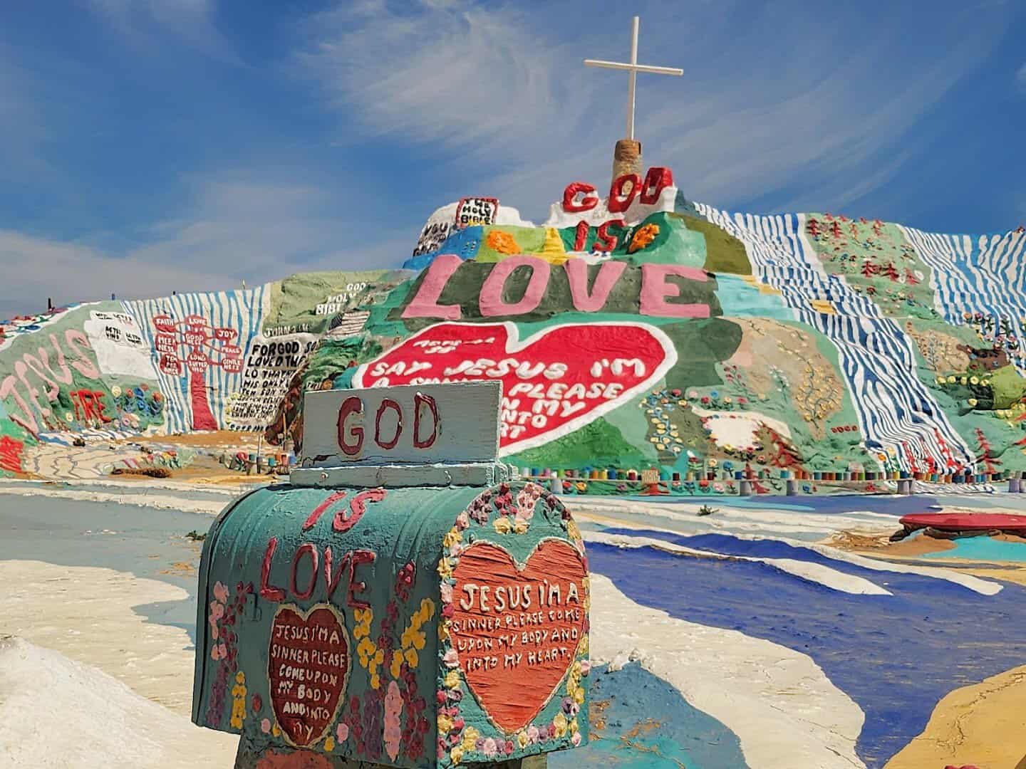 Salvation Mountain, a hillside painted with a cross and God Is Love near Niland, California