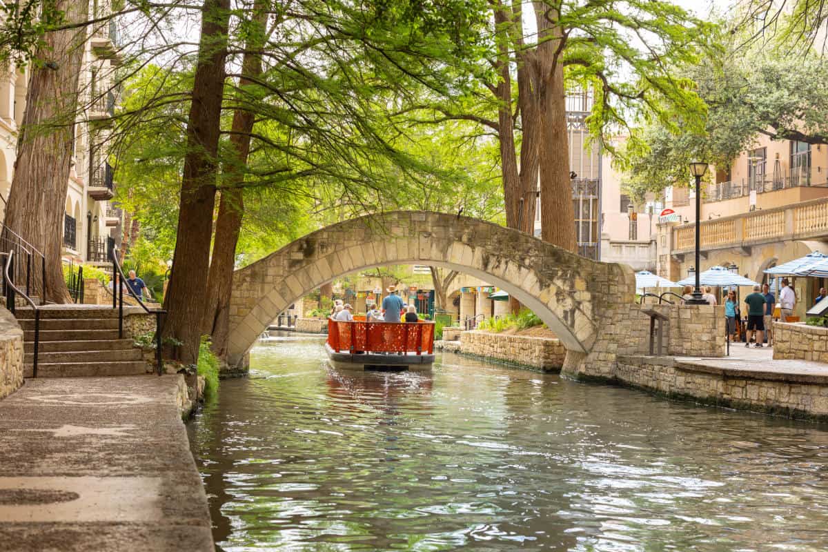 Arched stone footbridge over the San Antonio River Walk