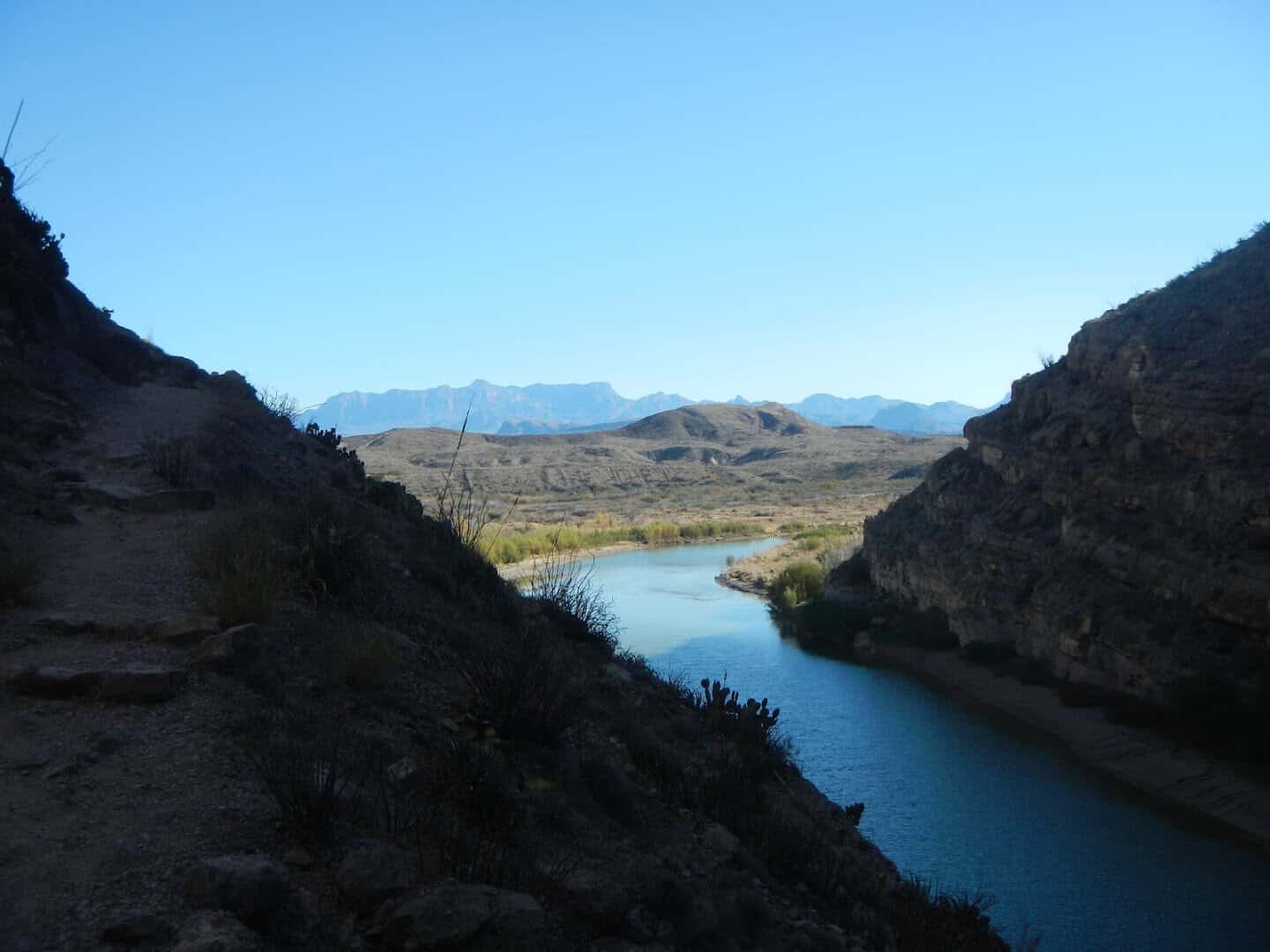 Santa Elena Canyon framing the Rio Grande and distant desert mountains in Big Bend National Park, Texas