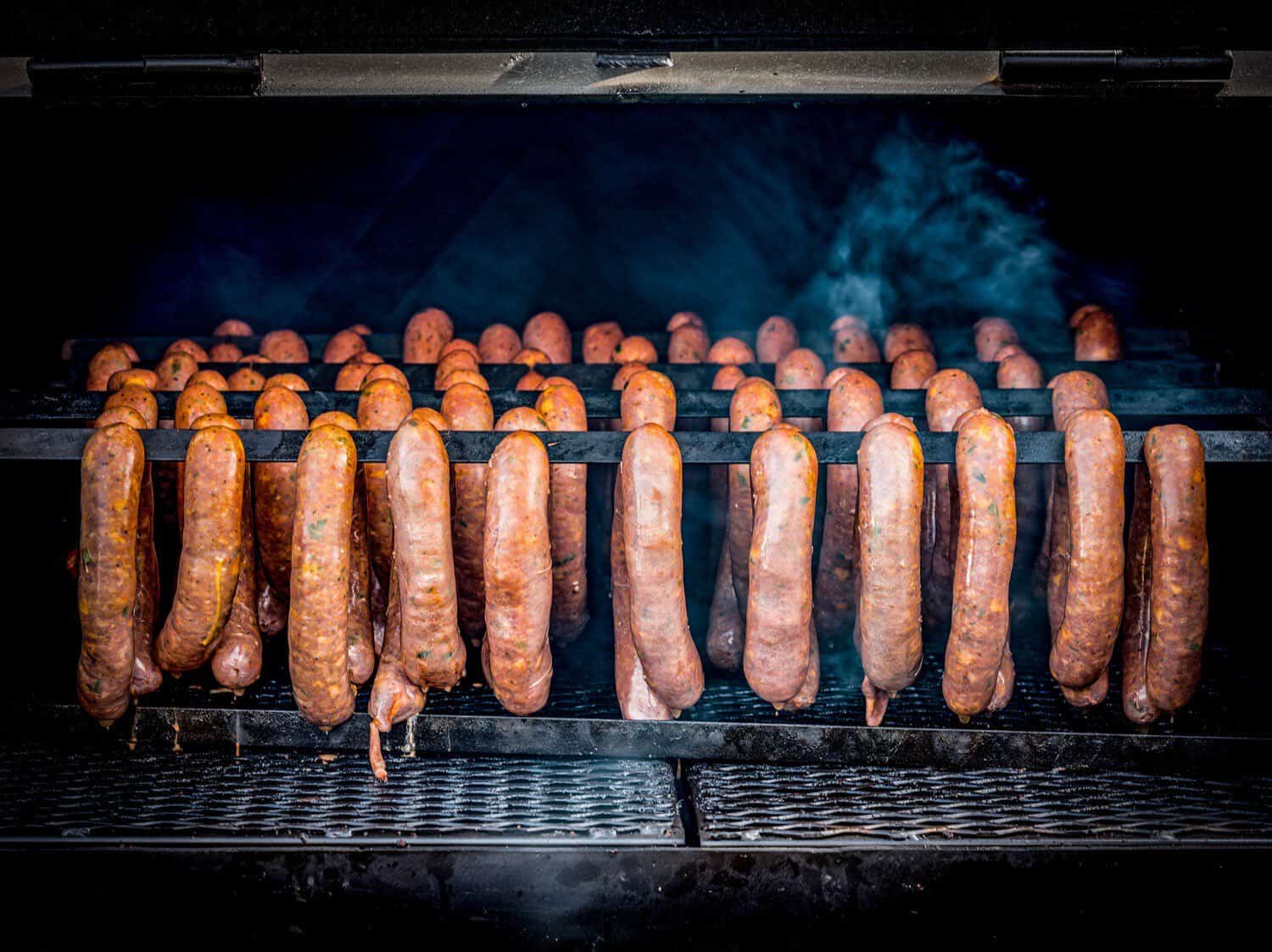 Sausage links smoking on the pit at Truth Barbeque in Brenham, Texas